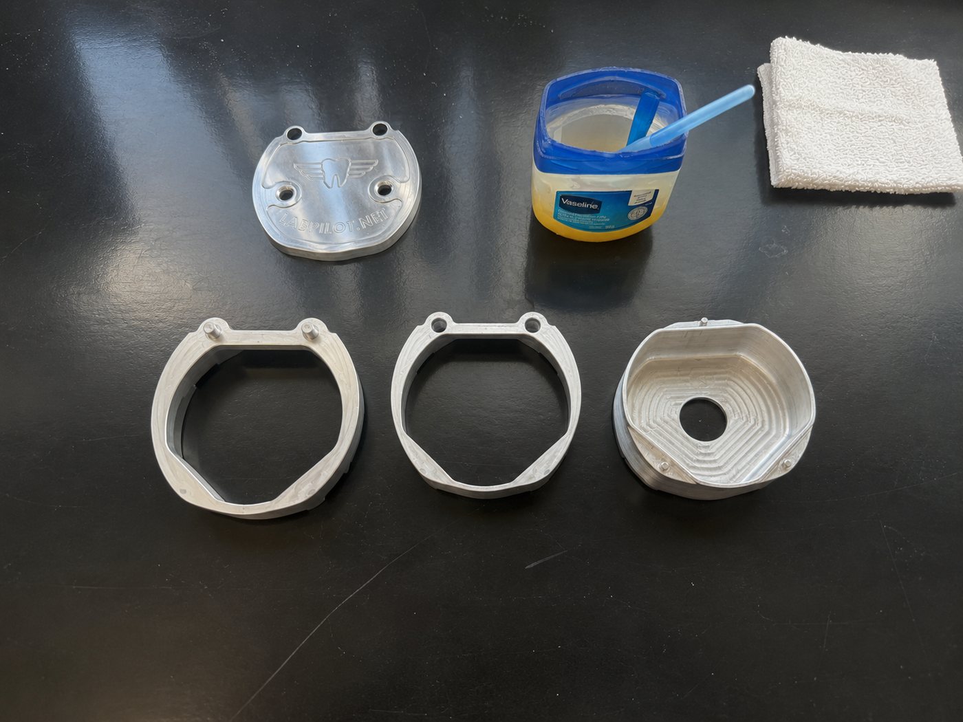 LabPilot flask lid, rings, base, Vaseline, and a cloth laid out on the bench