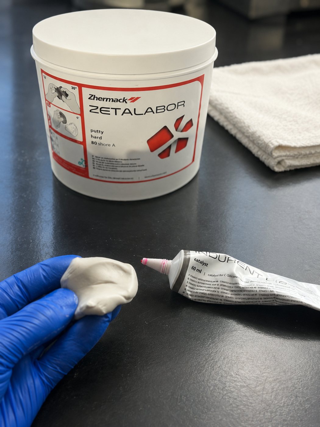 Zetalabor lab putty tub, Indurent catalyst, and mixed putty on the bench