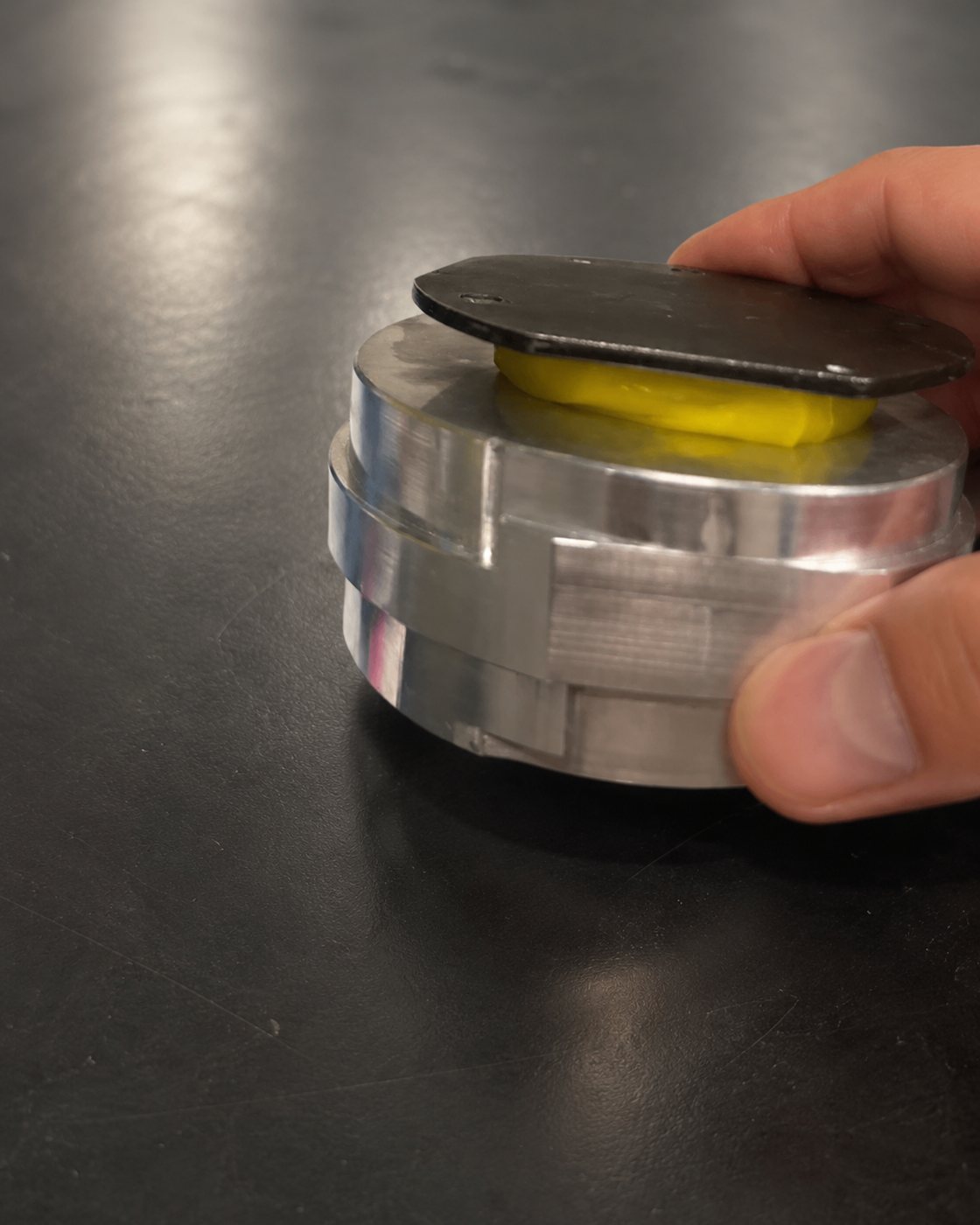 Hand separating the flask adapter from the flask base