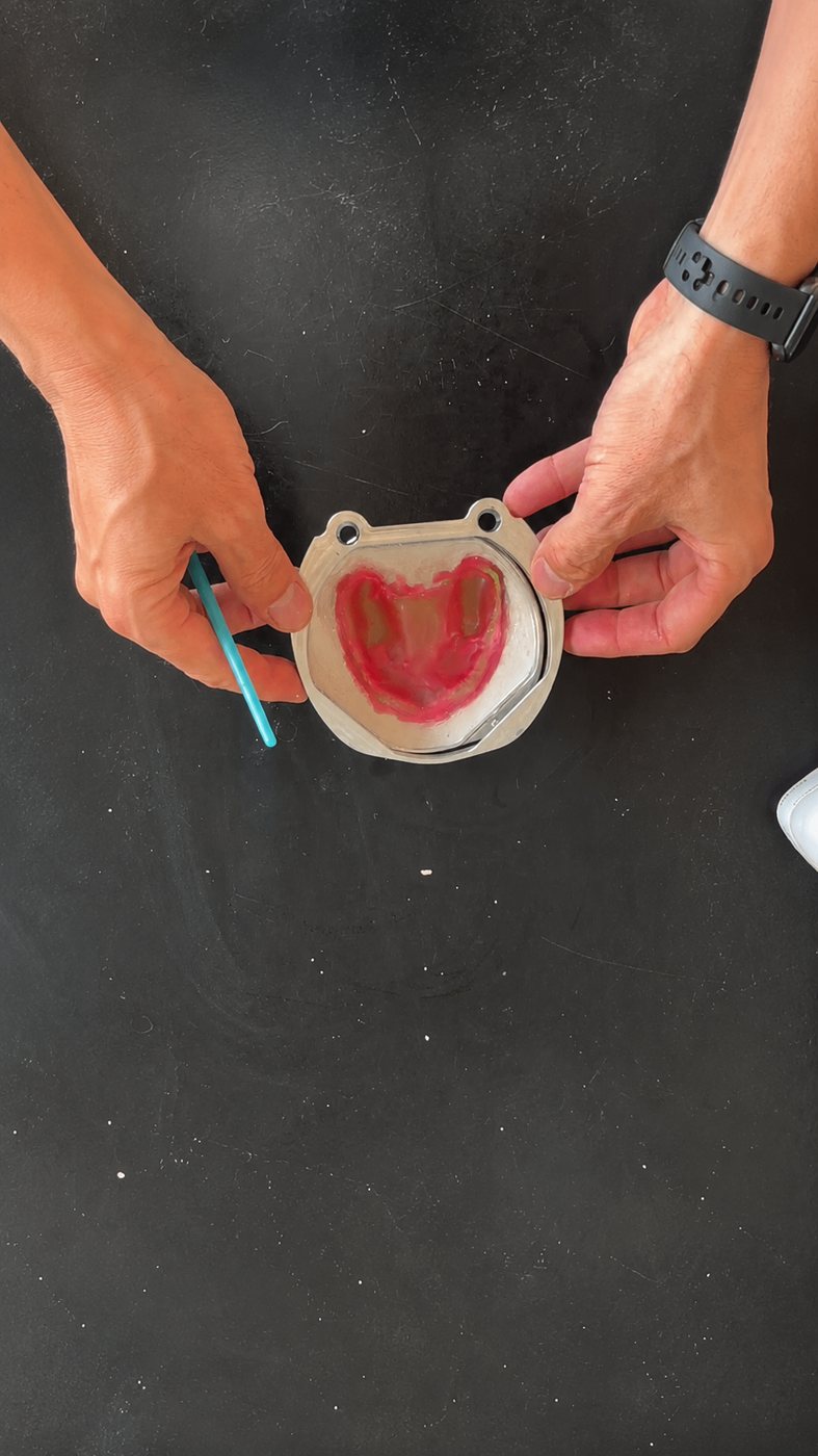 Hands aligning the mid flask section over the flask base